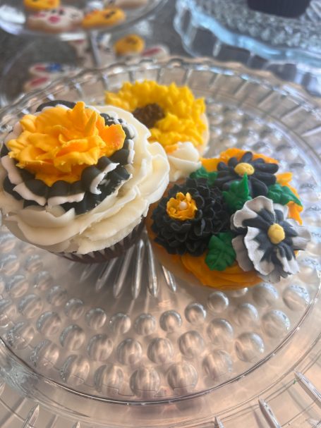 Let's Go Hawkeyes Cupcakes and frosted sugar cookies are adorned with beautiful Black, Gold, and White flowers.  