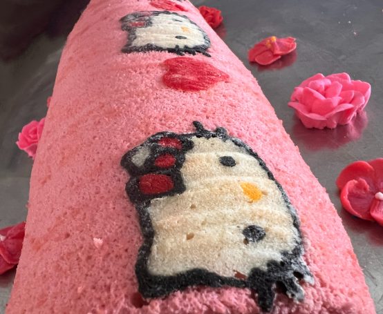 Japanese cake roll with a Hello Kitty pattern delicately embedded into the cake by hand.  Rolled with a strawberries and cream filling. 