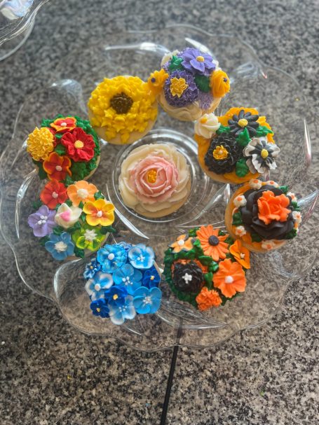 Frosted Sugar Cookies decorated with a mix of flowers in vibrant colors.  These are a local favorite.