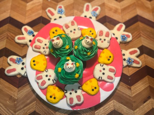An assortment of frosted sugar cookies and cupcakes exquisitely decorated for Easter.