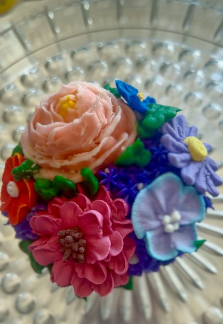 Flower Garden Cupcake decorated with a mix of flowers and colors.  Can be customized to your favorite colors, flowers, and flavors.